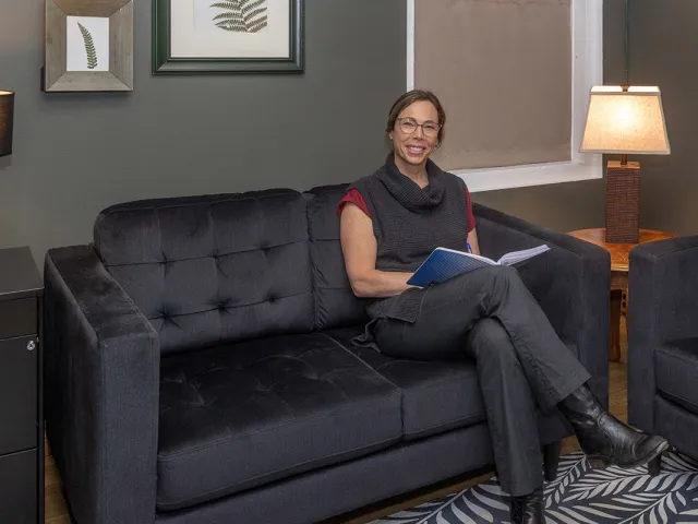 Karyn Dowdall on couch in office